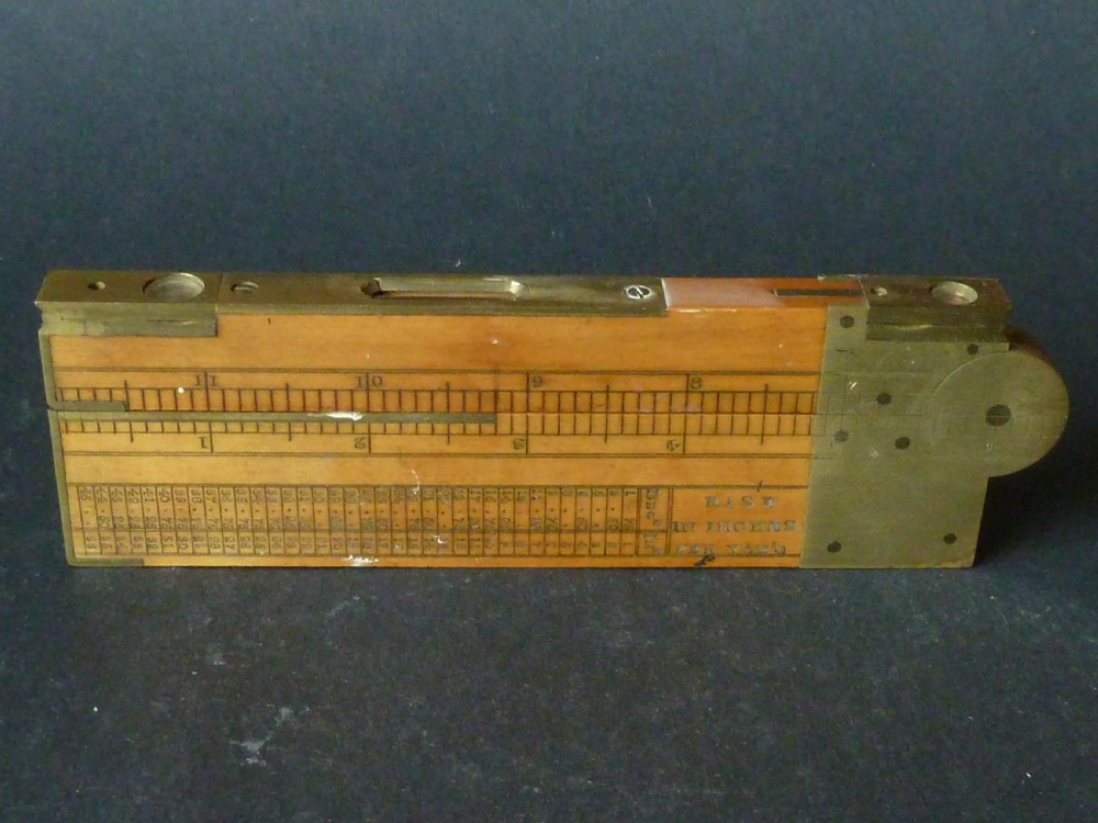 An antique boxwood and brass folding clinometer rule featuring an integrated magnetic compass, spirit level, folding sight vanes, and engraved measurement scales. View VIII