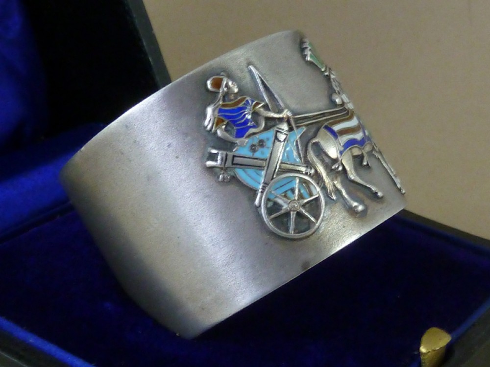 A curved 800 silver napkin ring featuring a detailed enamel relief depiction of a charioteer driving a horse in blue and green tones. View III