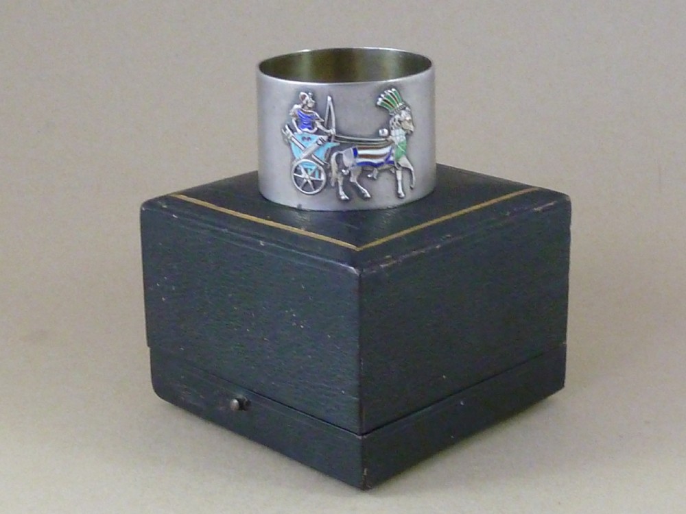 A curved 800 silver napkin ring featuring a detailed enamel relief depiction of a charioteer driving a horse in blue and green tones. View IV