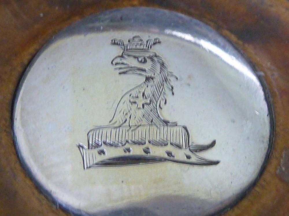 A pair of round Georgian sterling silver wine coasters with gadrooned rims, turned wooden bases, and central engraved silver bosses. View II