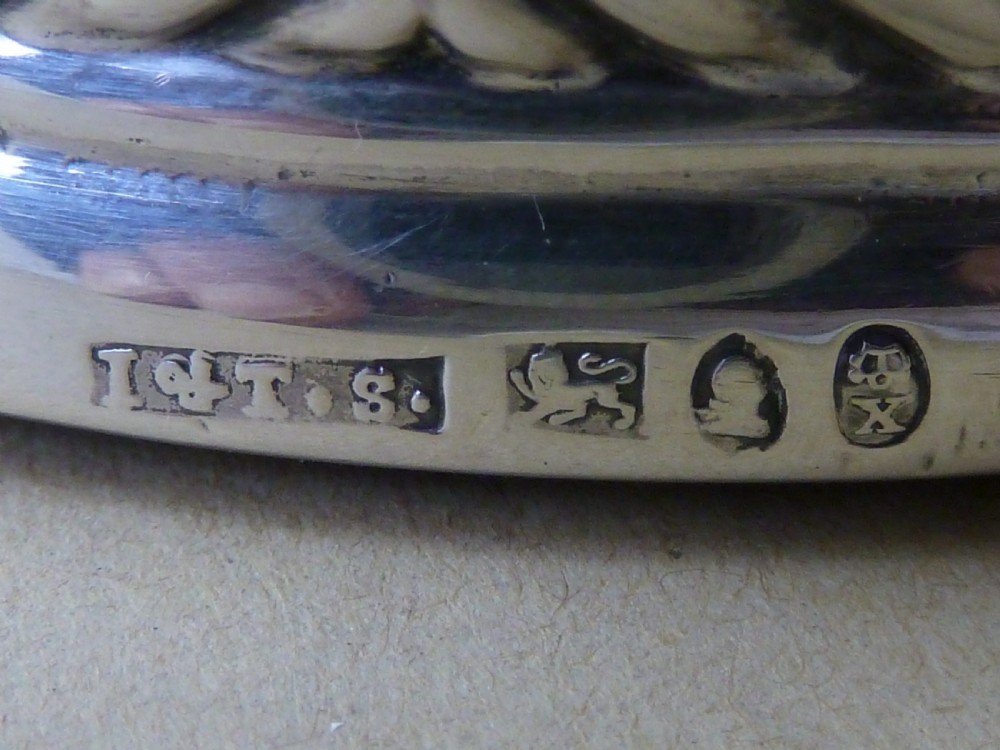A pair of round Georgian sterling silver wine coasters with gadrooned rims, turned wooden bases, and central engraved silver bosses. View VIII
