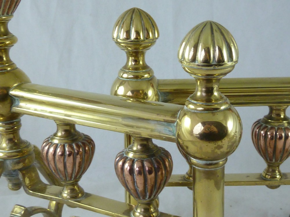 A pair of Victorian brass and copper fire dogs featuring ribbed urn-shaped finials, turned posts, and claw feet. View IV