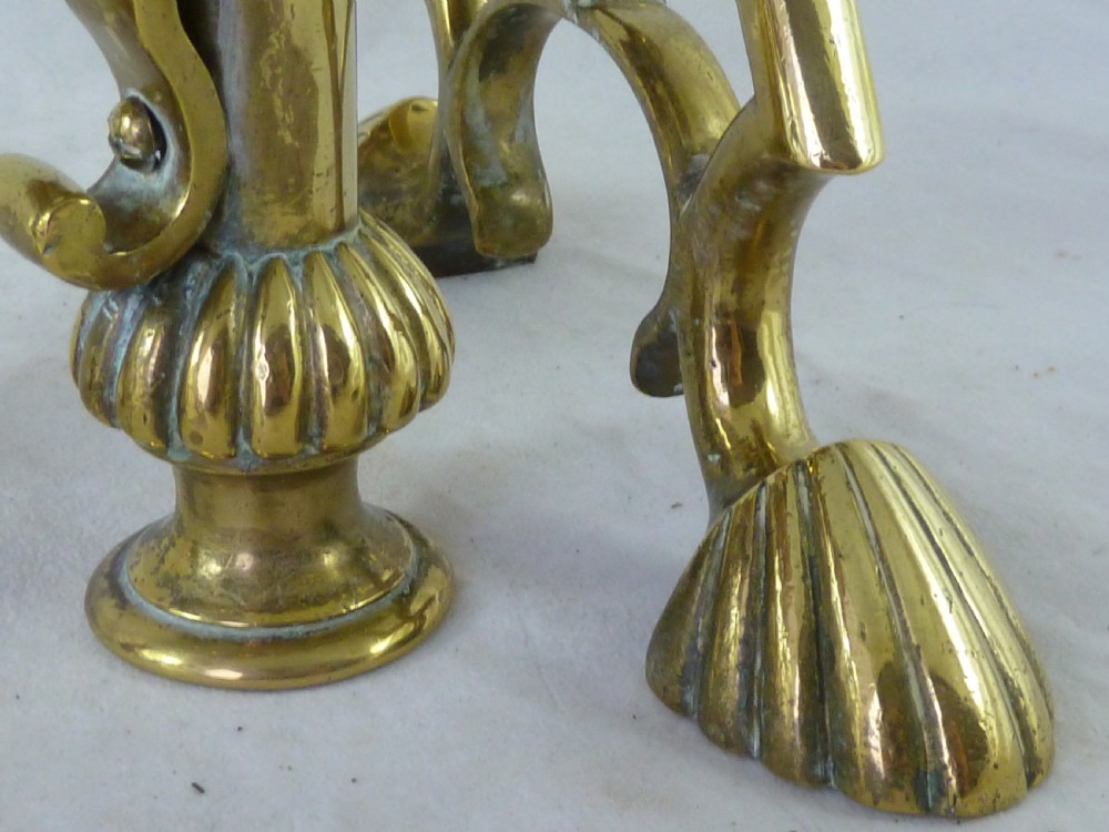 A pair of Victorian brass and copper fire dogs featuring ribbed urn-shaped finials, turned posts, and claw feet. View V