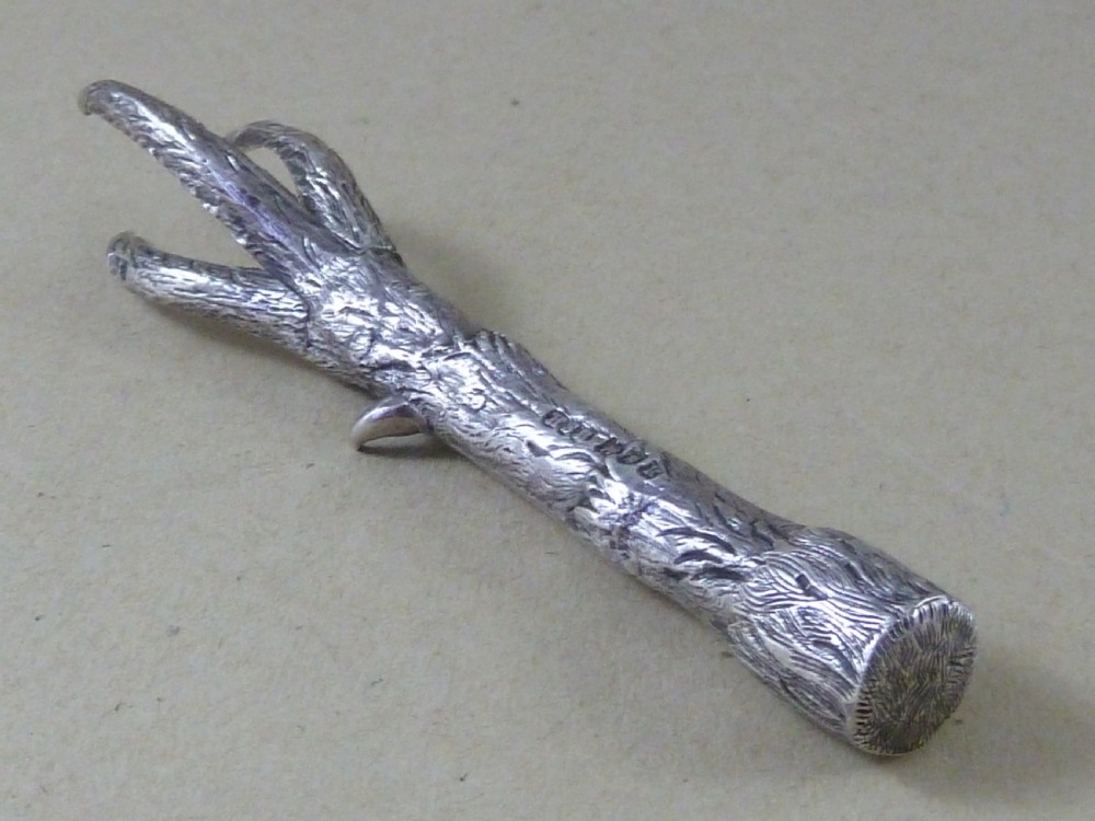 A hallmarked sterling silver sugar tongs crafted in the detailed shape of an articulated eagle claw. View III