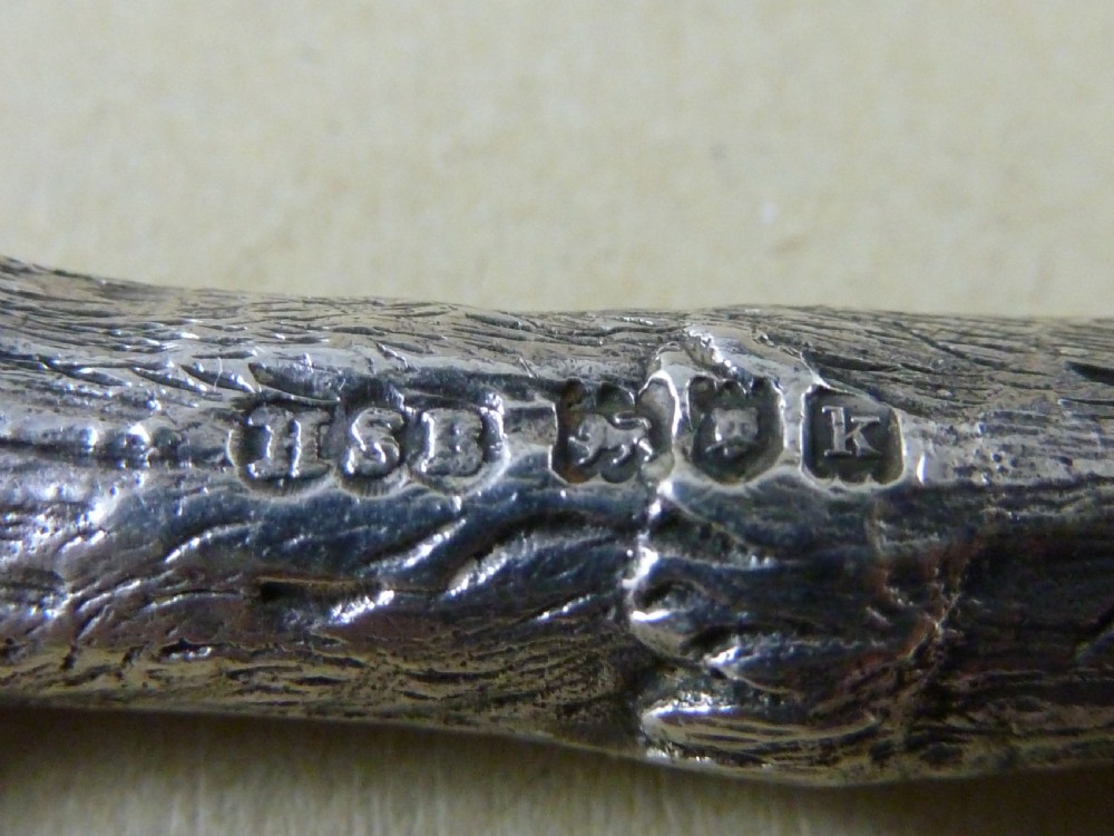 A hallmarked sterling silver sugar tongs crafted in the detailed shape of an articulated eagle claw. View IV