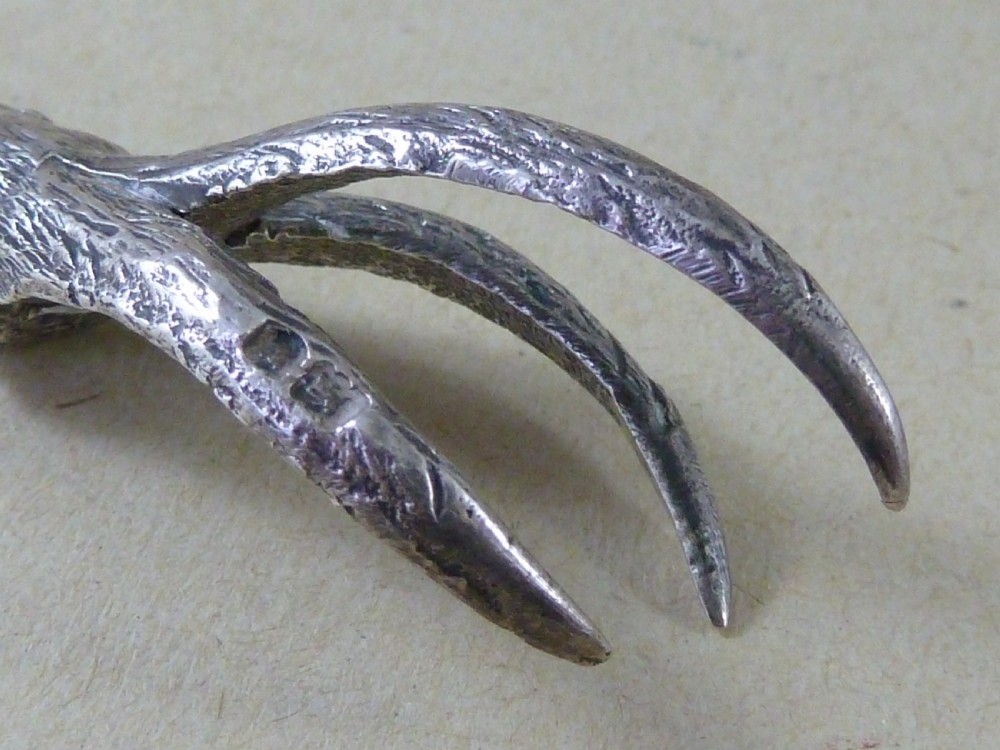 A hallmarked sterling silver sugar tongs crafted in the detailed shape of an articulated eagle claw. View V