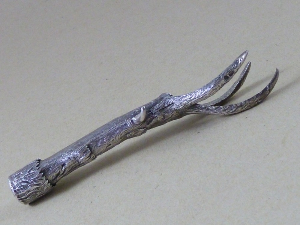 A hallmarked sterling silver sugar tongs crafted in the detailed shape of an articulated eagle claw. View VII