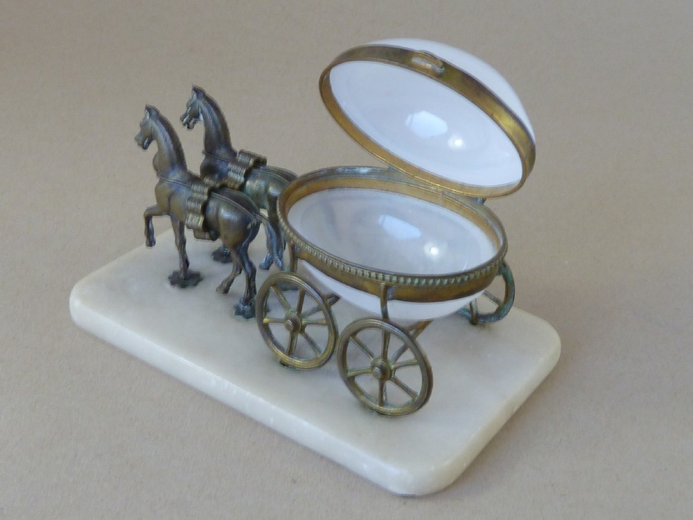 A French Palais Royal style miniature horse-drawn carriage featuring a white opaline glass egg-shaped casket mounted on a gilt metal frame and alabaster base. View IV