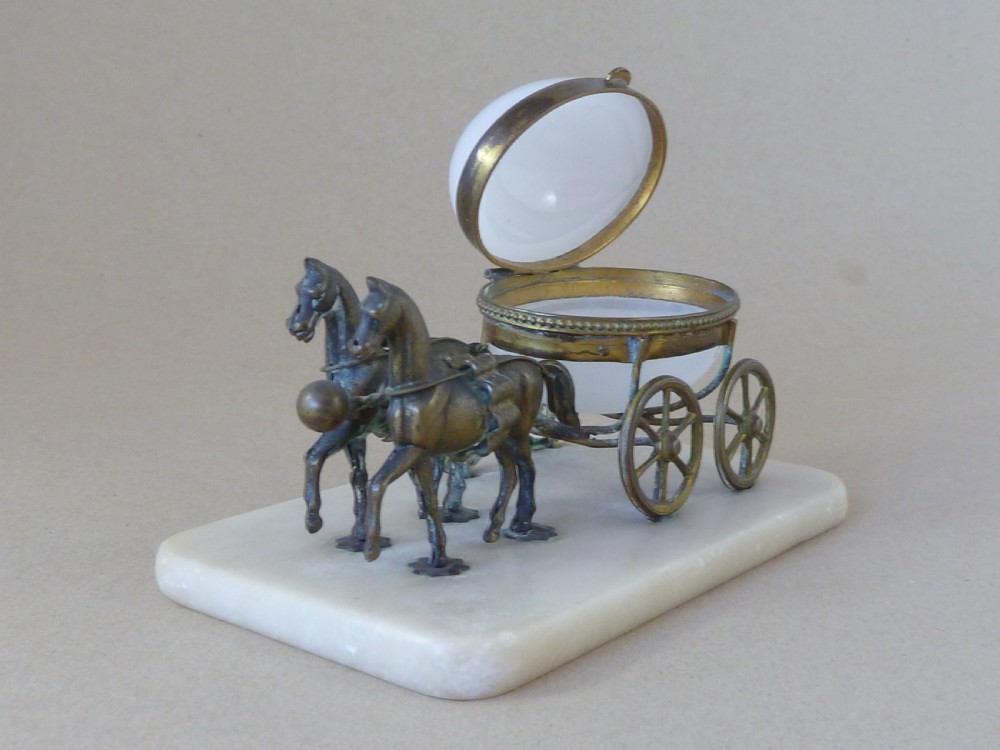 A French Palais Royal style miniature horse-drawn carriage featuring a white opaline glass egg-shaped casket mounted on a gilt metal frame and alabaster base. View V