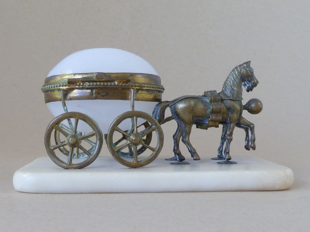 A French Palais Royal style miniature horse-drawn carriage featuring a white opaline glass egg-shaped casket mounted on a gilt metal frame and alabaster base. View VI