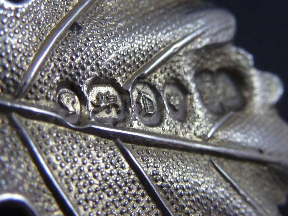 A Victorian sterling silver decanter label shaped as a vine leaf, pierced with the word PORT and attached to a metal suspension chain. View II