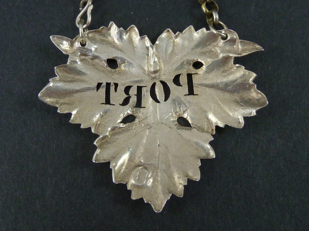 A Victorian sterling silver decanter label shaped as a vine leaf, pierced with the word PORT and attached to a metal suspension chain. View III