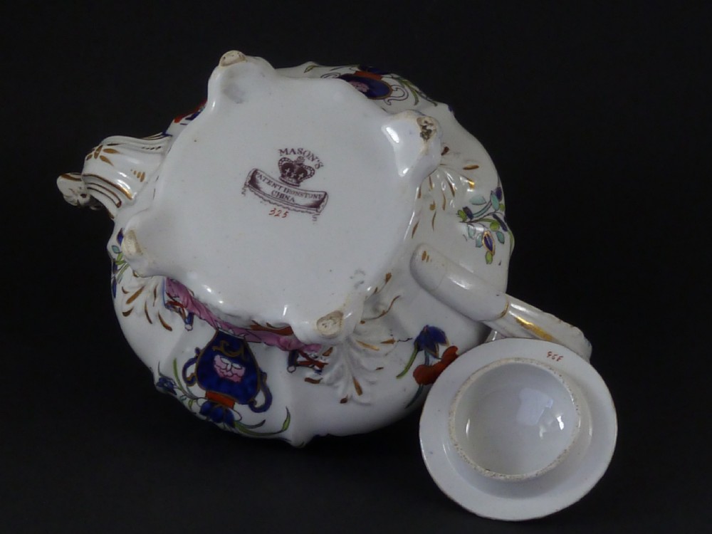 A Masons ironstone tea set featuring a teapot, milk jug, and teacup with saucer in cobalt blue, pink, and yellow enamelling with gilded details. View III