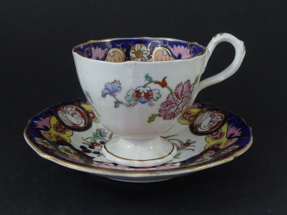 A Masons ironstone tea set featuring a teapot, milk jug, and teacup with saucer in cobalt blue, pink, and yellow enamelling with gilded details. View VIII