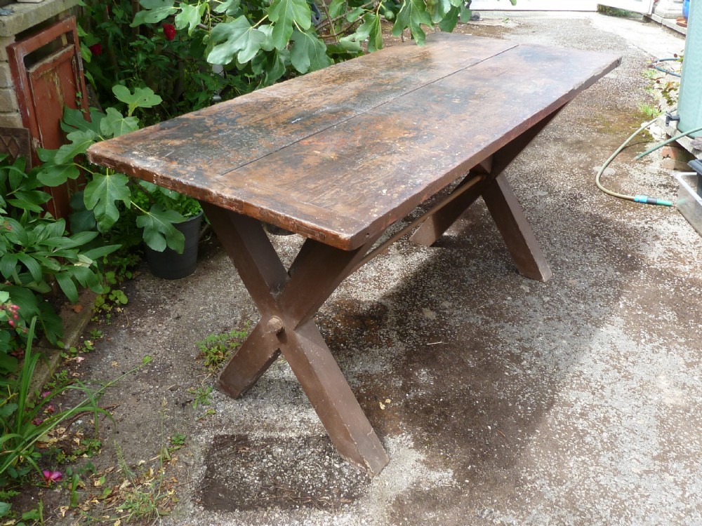 A rustic painted pine tavern table featuring an X-frame trestle base, an iron stretcher rod, and a weathered two-plank top with cleated ends. View II