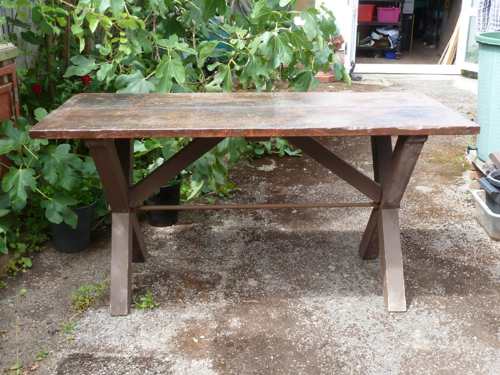 A rustic painted pine tavern table featuring an X-frame trestle base, an iron stretcher rod, and a weathered two-plank top with cleated ends. View IV