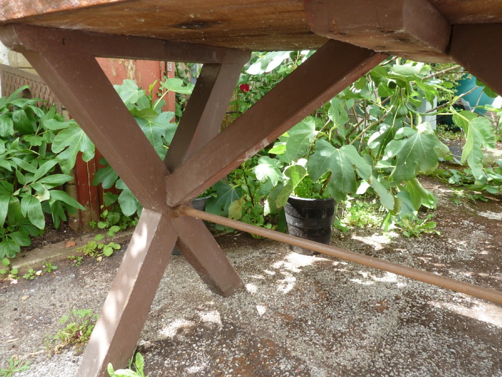 A rustic painted pine tavern table featuring an X-frame trestle base, an iron stretcher rod, and a weathered two-plank top with cleated ends. View VI