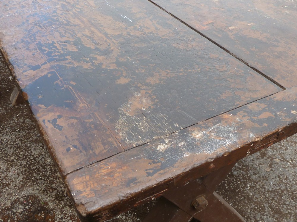 A rustic painted pine tavern table featuring an X-frame trestle base, an iron stretcher rod, and a weathered two-plank top with cleated ends. View XI