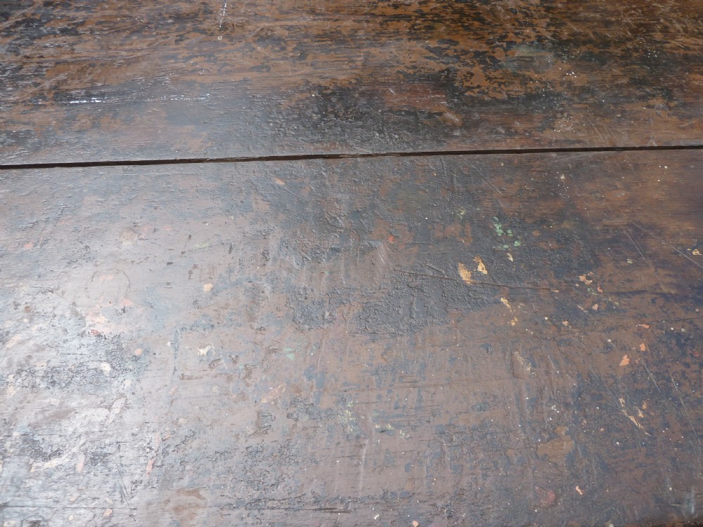 A rustic painted pine tavern table featuring an X-frame trestle base, an iron stretcher rod, and a weathered two-plank top with cleated ends. View XIII
