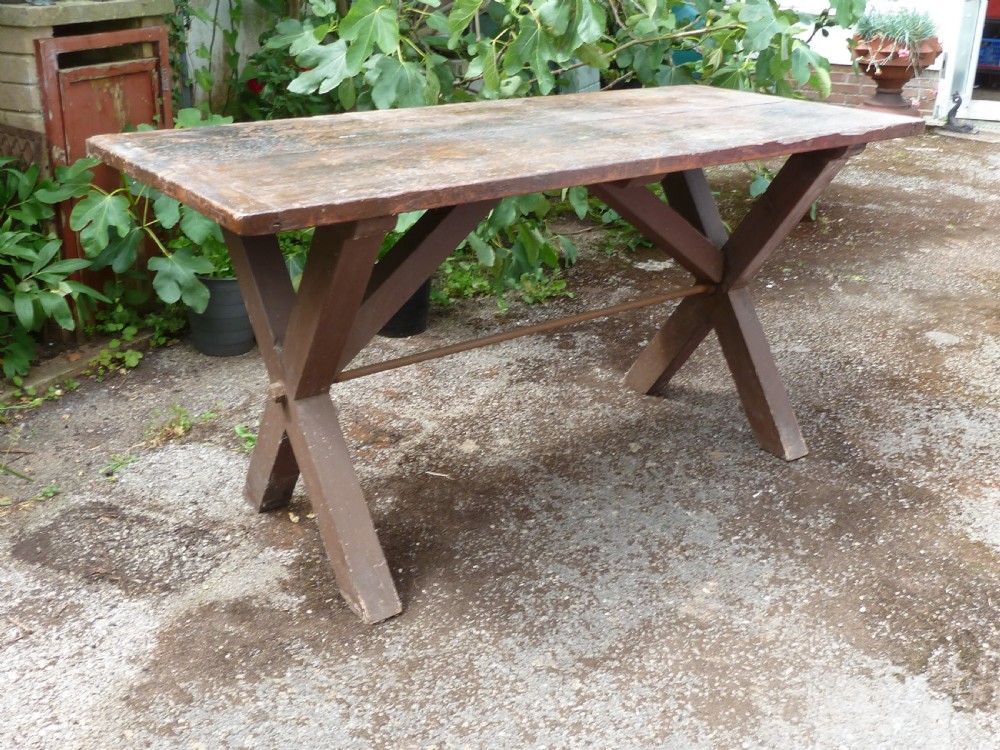 A rustic painted pine tavern table featuring an X-frame trestle base, an iron stretcher rod, and a weathered two-plank top with cleated ends. View XIV