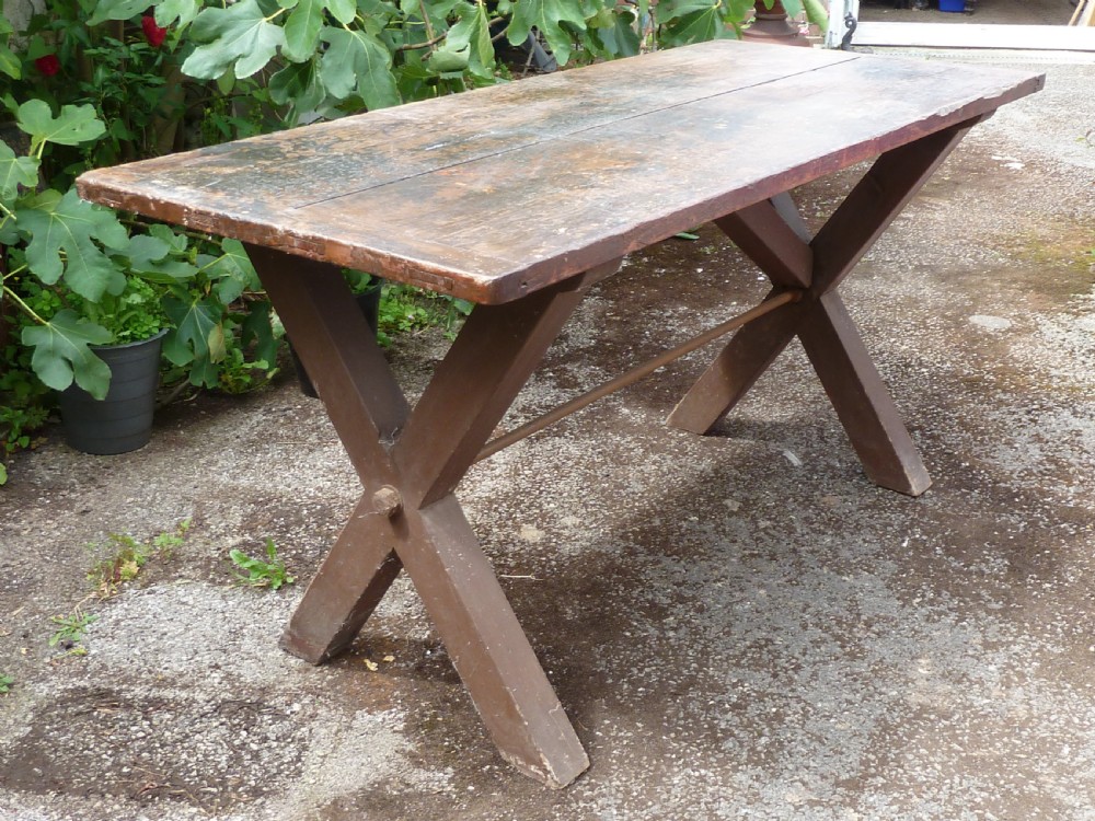 A rustic painted pine tavern table featuring an X-frame trestle base, an iron stretcher rod, and a weathered two-plank top with cleated ends. View XV