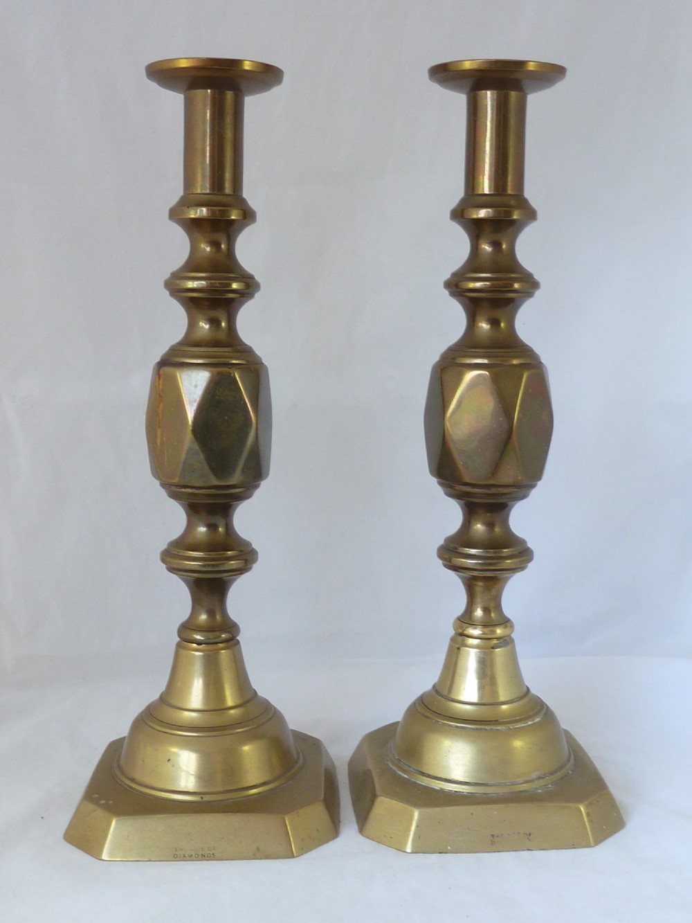 A pair of 14-inch Victorian cast brass candlesticks featuring faceted diamond-shaped centre knops and octagonal stepped bases. View II