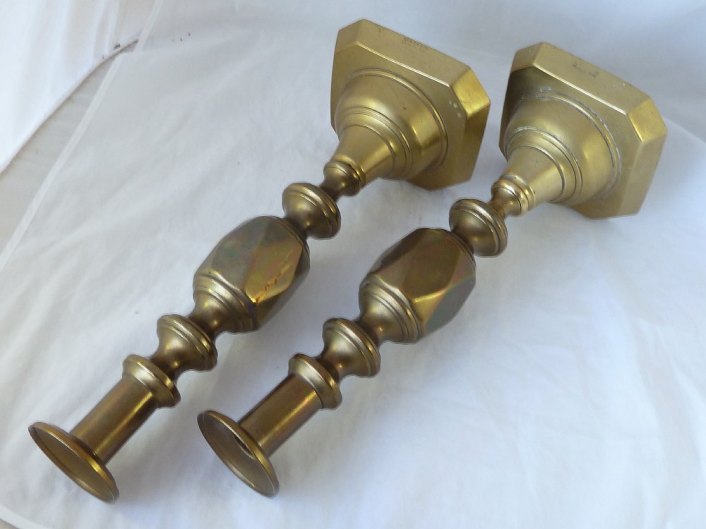 A pair of 14-inch Victorian cast brass candlesticks featuring faceted diamond-shaped centre knops and octagonal stepped bases. View IV