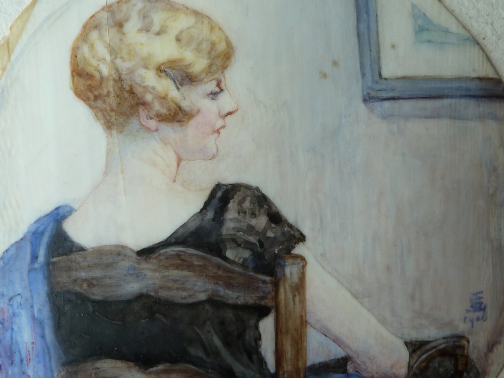 A circular Art Deco hand-painted portrait miniature depicting a 1920s blonde woman in a black dress with a blue wrap, set within an etched circular metal frame. View III