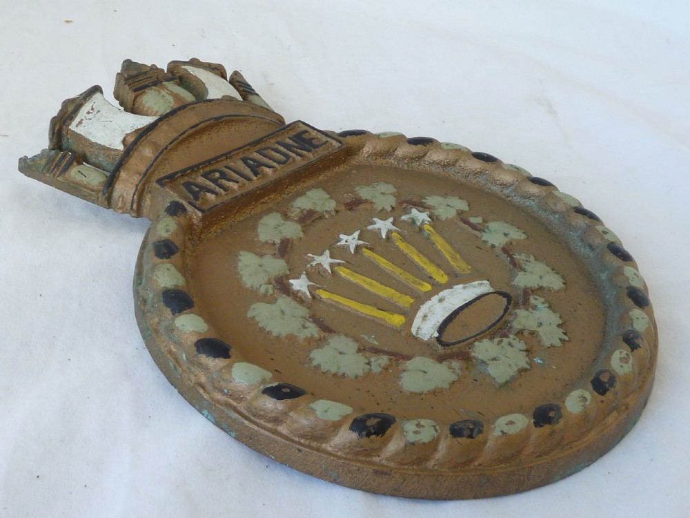 A circular cast bronze Royal Navy ship crest for HMS Ariadne featuring a naval crown top and rope border. View II
