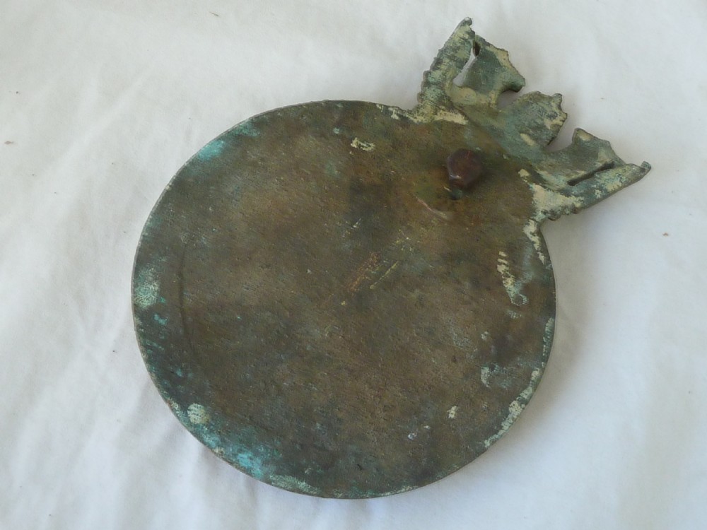 A circular cast bronze Royal Navy ship crest for HMS Ariadne featuring a naval crown top and rope border. View IV