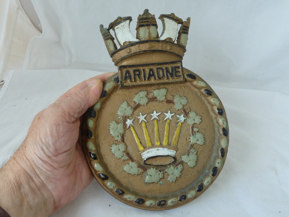 A circular cast bronze Royal Navy ship crest for HMS Ariadne featuring a naval crown top and rope border. View V