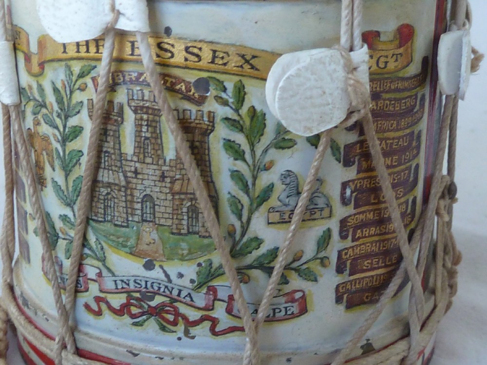 A miniature painted regimental snare drum with rope tensioning enclosed within a brass-bound glass display case on a dark timber base. View V