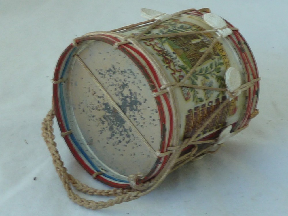 A miniature painted regimental snare drum with rope tensioning enclosed within a brass-bound glass display case on a dark timber base. View VIII