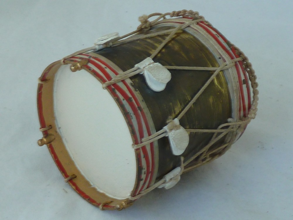 A miniature painted regimental snare drum with rope tensioning enclosed within a brass-bound glass display case on a dark timber base. View IX