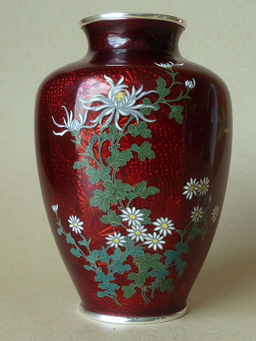 A crimson red translucent enamel vase decorated with silver wire chrysanthemums and silver rims. View II