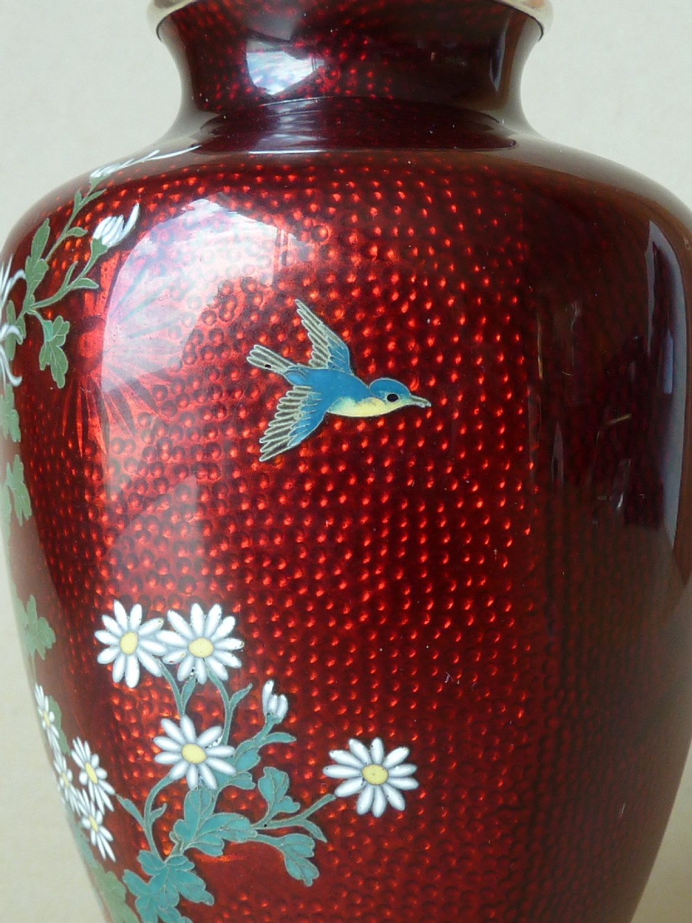A crimson red translucent enamel vase decorated with silver wire chrysanthemums and silver rims. View III