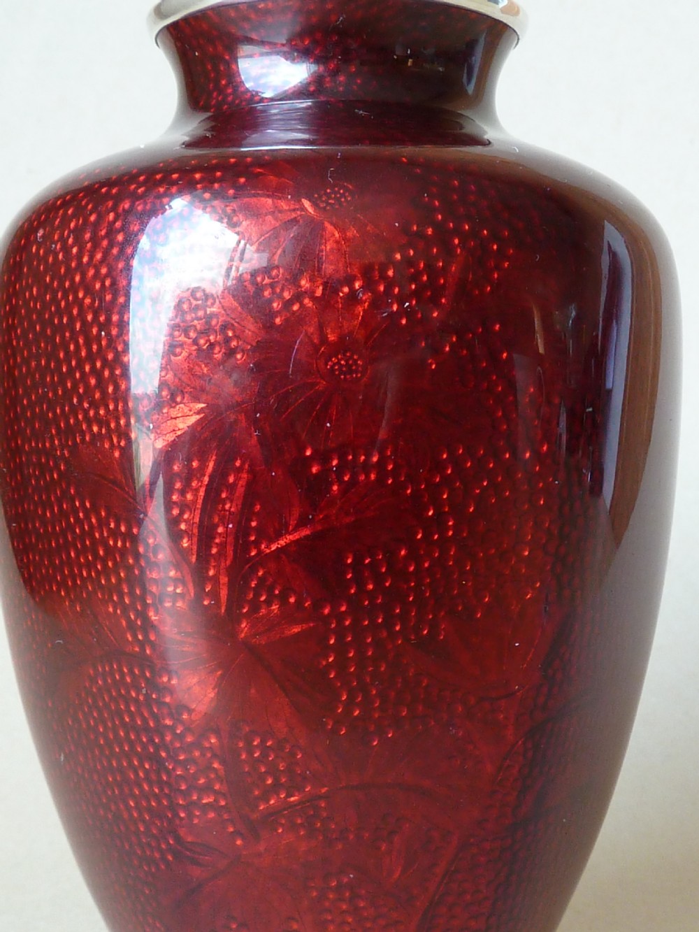 A crimson red translucent enamel vase decorated with silver wire chrysanthemums and silver rims. View IV