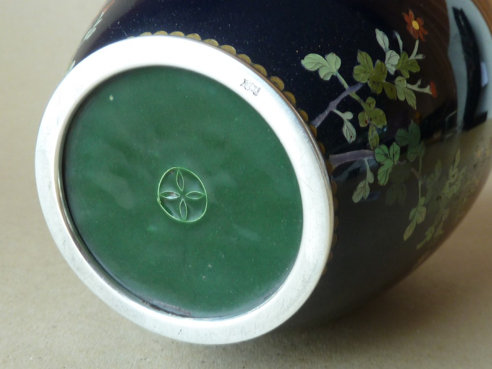 A black Japanese cloisonne enamel vase decorated with silver wire depicting white blossoms, foliage, and birds, finished with silver rim and foot rim. View IX
