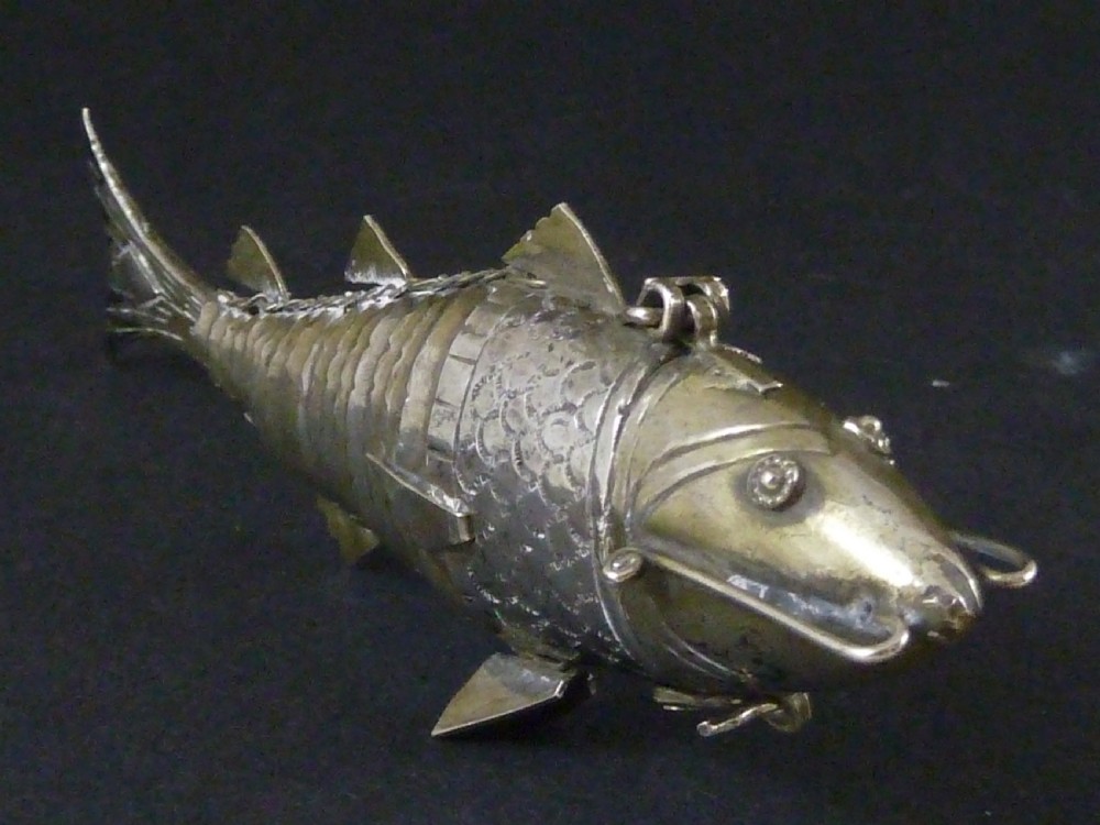An articulated silver spice box crafted in the form of a detailed fish with overlapping scales and fins. View IV