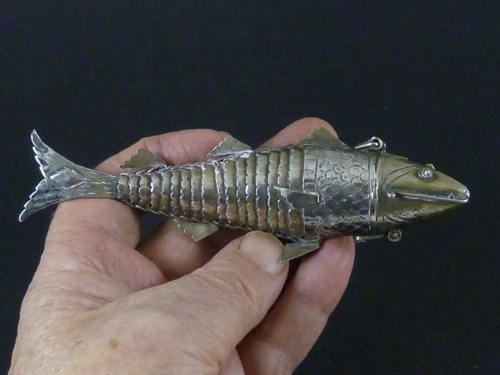 An articulated silver spice box crafted in the form of a detailed fish with overlapping scales and fins. View VII