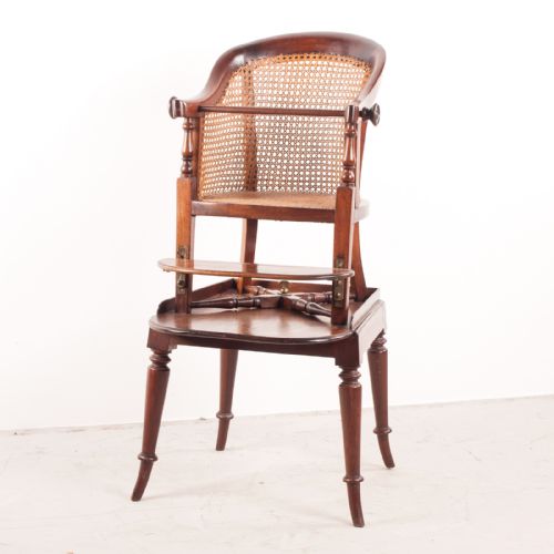 fig 1. A 19th-century childs tub high chair crafted from rich mahogany with woven cane panelling and turned front legs.