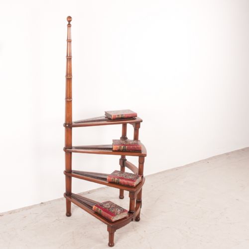 fig 1. A spiral set of dark mahogany library steps with four leather-lined triangular treads and a central turned handrail post.