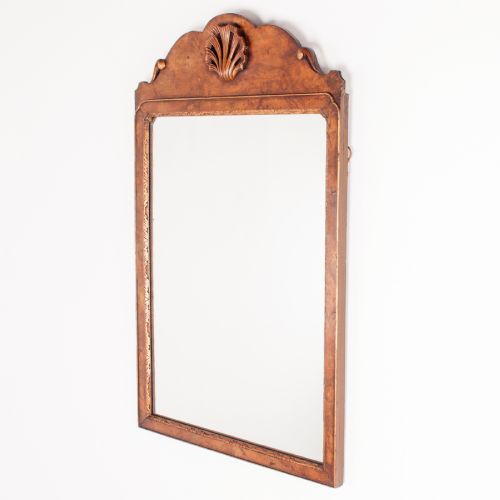 fig 1. A rectangular walnut wall mirror with a contoured pediment top featuring a hand-carved shell motif.