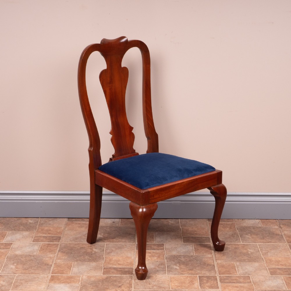 A small mahogany childs chair featuring a vasiform back splat, cabriole front legs, and a dark blue velvet drop-in seat.