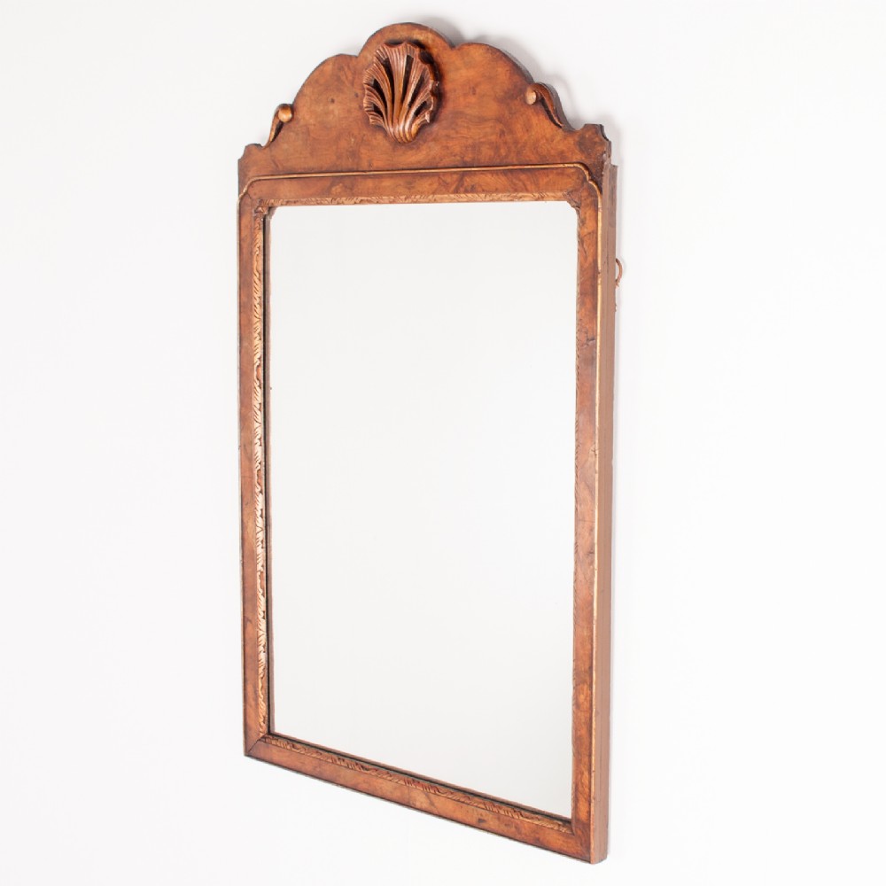 A rectangular walnut wall mirror with a contoured pediment top featuring a hand-carved shell motif. View II