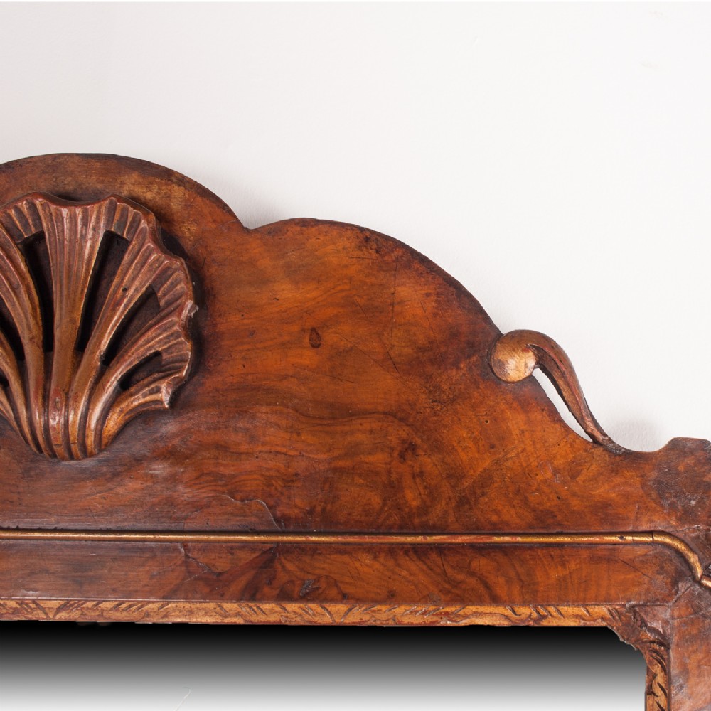 A rectangular walnut wall mirror with a contoured pediment top featuring a hand-carved shell motif. View VII