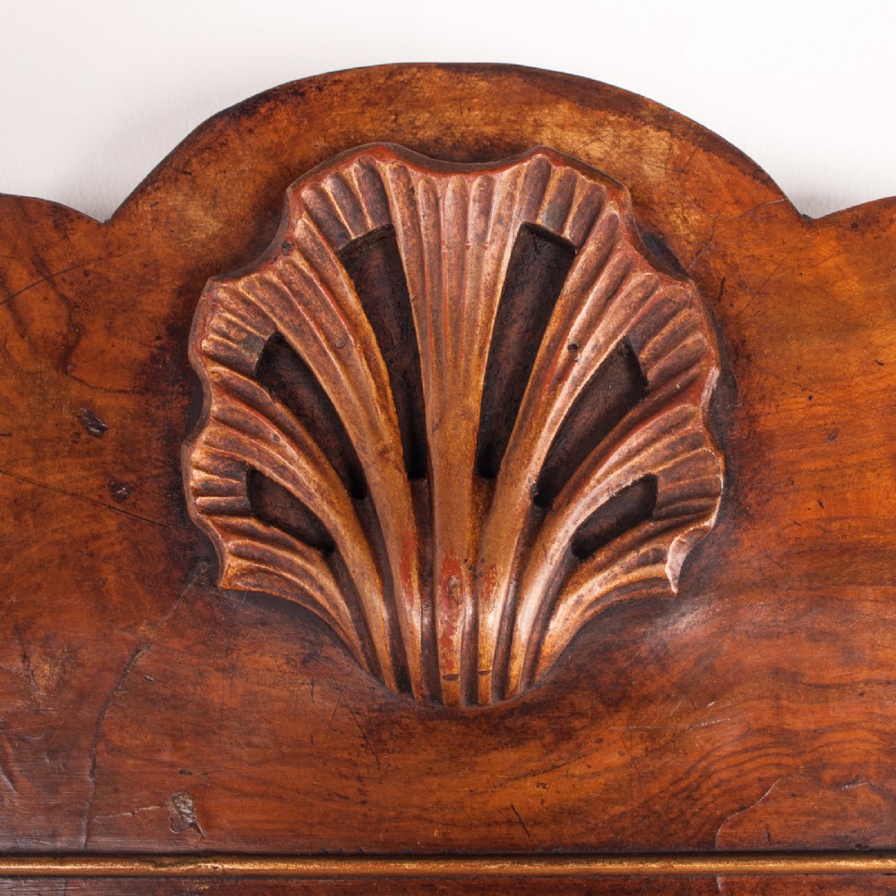 A rectangular walnut wall mirror with a contoured pediment top featuring a hand-carved shell motif. View VIII