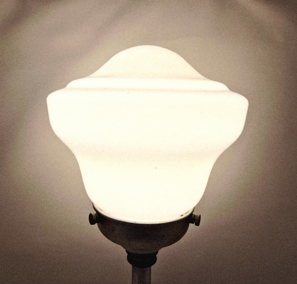 An Art Deco table lamp featuring a stepped polished chrome base, slender vertical column, and a white frosted glass shade. View II