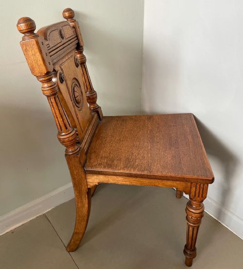 AN ANTIQUE PAIR OF HONEY OAK AESTHETIC MOVEMENT HALL CHAIRS - ADDITIONAL PHOTO 2