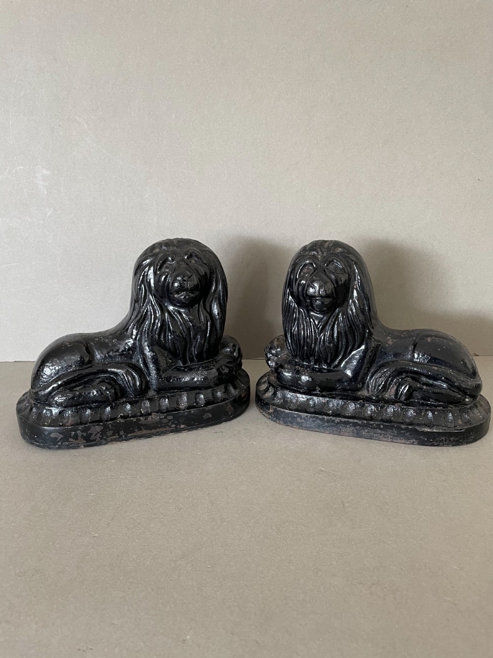 A pair of 19thC cast iron lion door porters